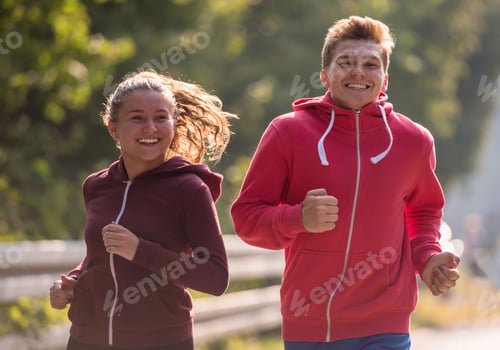 Preview: young couple jogging along a country road