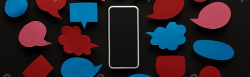 Preview: panoramic shot of smartphone with blank screen on black background with empty red and blue speech