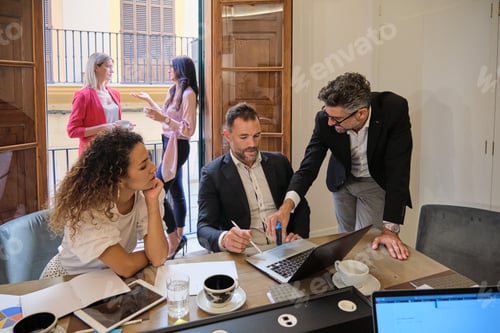 Preview: Colleagues talking about work in office