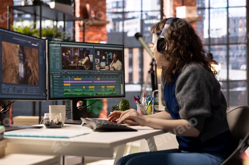 Preview: Female filmmaker working on media post production from agency office