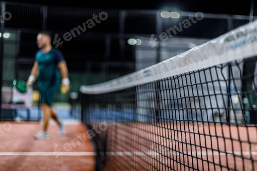 Preview: Padel players enjoying a match at night on a well-lit court