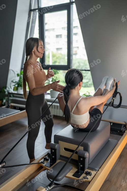Preview: Women Doing Pilates in a Modern Studio to Enhance Skills and Improve Health and Wellbeing