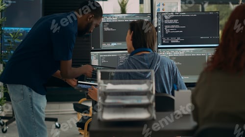 Preview: Diverse team of data programers analyzing code programming on laptop