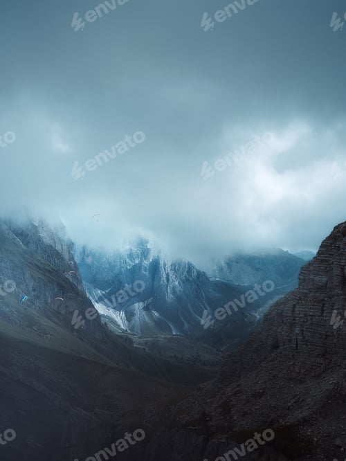 Preview: A group of paragliders gliding over the side of Mount Seceda, Dolomites, Italy