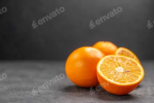 Preview: Horizontal view of fresh whole and sliced lemons on dark background stock image