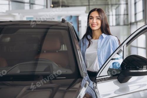 Preview: Happy friendly woman customer buyer client wears blue shirt stand inside car dealership chooses auto