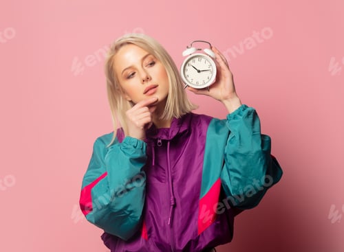 Preview: Beautiful blonde woman in 90s clothes with alarm clock
