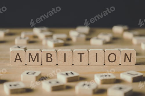 Preview: selective focus of cubes with word ambition surrounded by blocks with letters on wooden surface