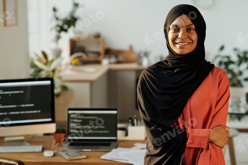 Preview: Young smiling Muslim home office worker looking at camera