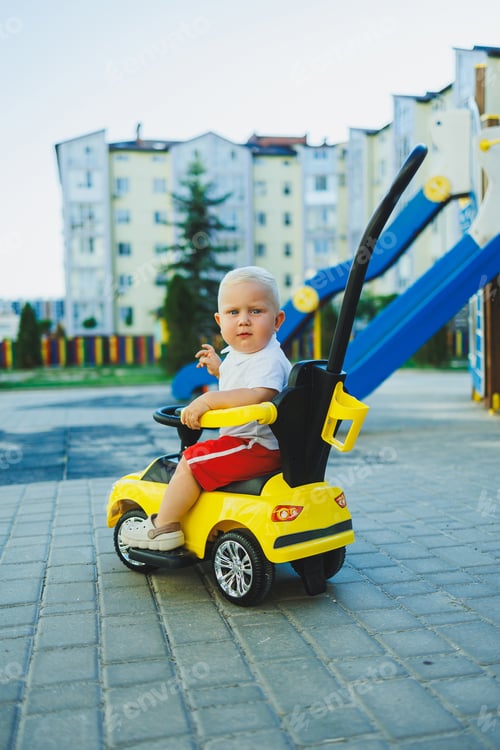 Preview: A little boy rides a tolocar. Tolokar for babies. Children's car for skating.