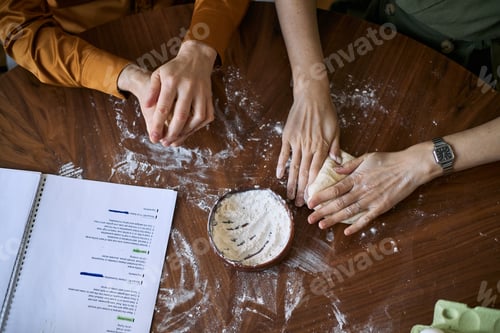 Preview: Adult Family Members Kneading Dough Together for Home Baking