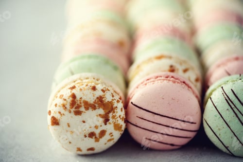 Preview: Colorful french macaroons flat lay. Pastel colors pink, green, yellow macarons with copy space, top