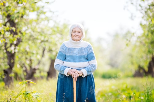 Preview: Senior woman on a walk in the orchard