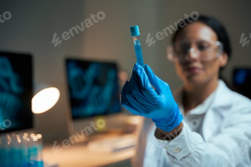 Preview: Scientist holding test tube doing research in laboratory