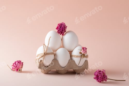 Preview: Composition with Easter eggs and eco-decor of dried roses on a beige background. Happy Easter