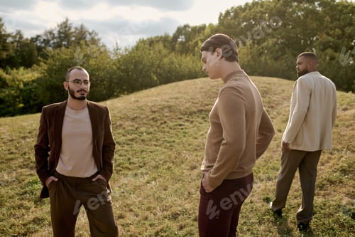 Preview: Stylish men in autumnal attire pose gracefully in a sunlit field surrounded by nature