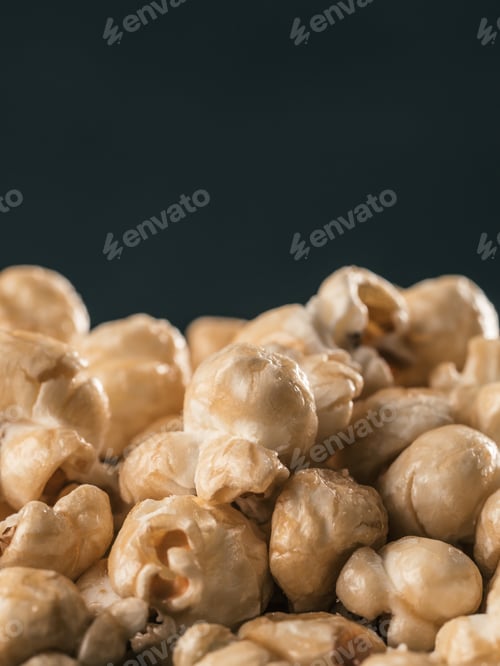 Preview: pile of caramel corn on black background
