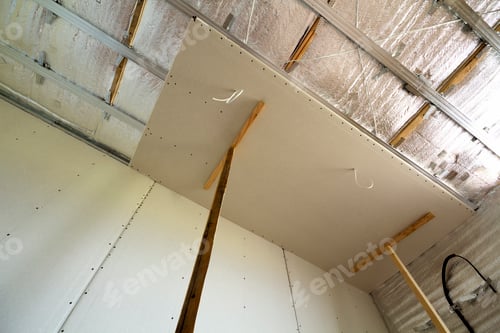 Preview: Room under construction with silver aluminum insulation foil and drywall on walls and ceiling.