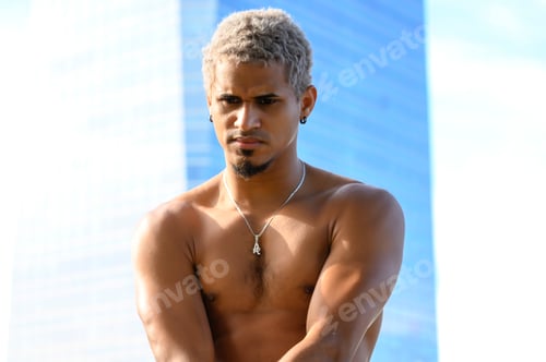 Preview: Portrait of an American dancer in the city street with his shirt off.