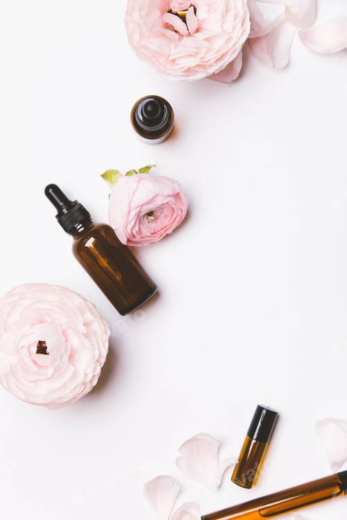 Preview: Essential Oils and Light Pink Flowers on White