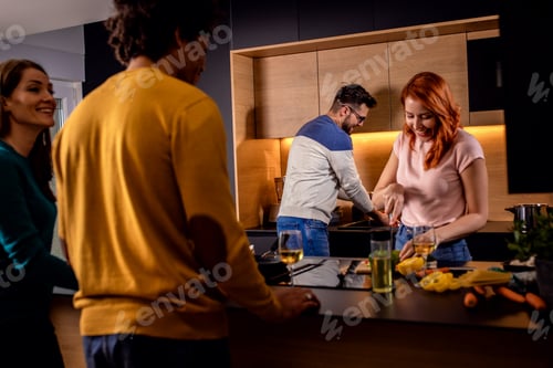 Preview: Group of friends having dinner party at home drinking wine and eating vegetarian food.