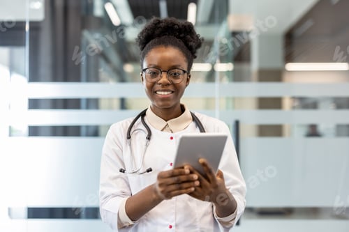 Preview: Smiling doctor using digital tablet in modern medical office