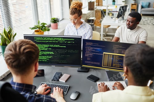Preview: Software developers working with computers at office
