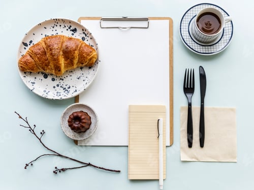 Preview: Aerial view of croissant coffee cup and paper clipboard