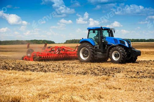 Preview: New blue tractor in motion at demonstration field site at agro exhibition working with harrows