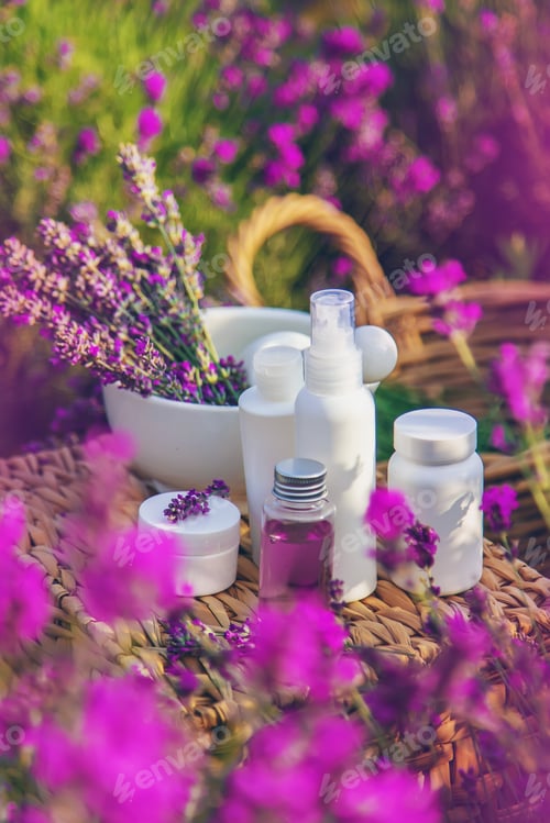 Preview: Lavender cosmetics in a field with flowers. Selective focus.