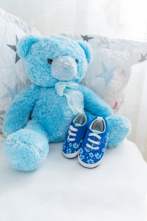 Preview: children's bed with a teddy blue bear and children's small shoes nearby, children's room interior.