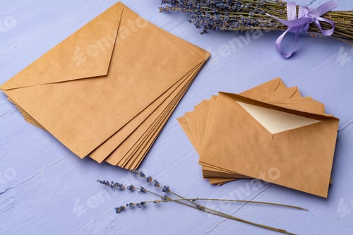 Preview: Letter envelope on lavender wooden background, copy space