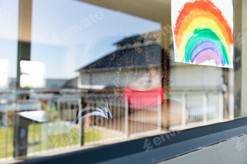 Preview: Boy wearing face mask looking out to the window