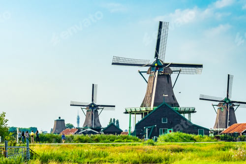 Preview: Windmills in Kinderdijk under the sunlight and a blue cloudy sky in the Netherlands