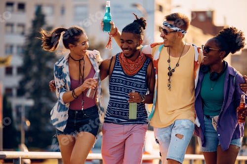 Preview: Cheerful friends having fun while going to summer music concert.