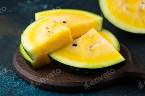 Preview: Cut yellow watermelon on table. Fresh summer food. Healthy nutrition