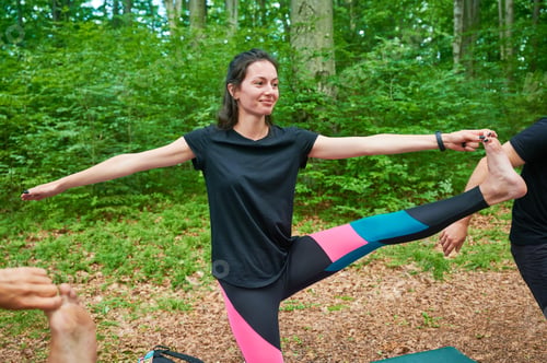 Preview: Woman practicing yoga outdoors in the mountains in a serene, natural setting.