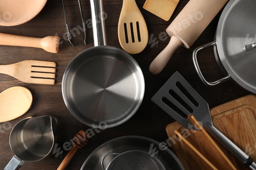 Preview: Different kitchen utensil on wooden background, top view
