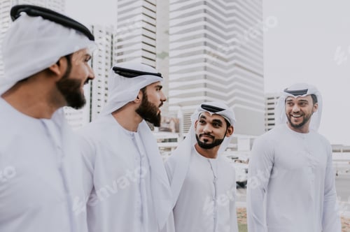 Preview: Group of businessmen talking on the street in Dubai