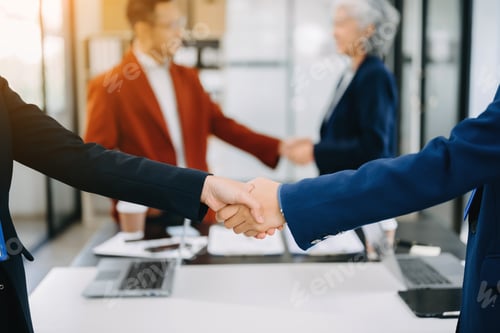 Preview: Business partnership handshake concept.Photo two coworkers handshaking process.Successful deal