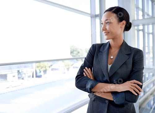 Preview: Focused on success. An attractive businesswoman standing in an office environment.