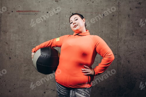 Preview: fat attractive girl with ball at gym.