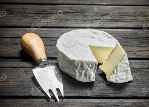 Preview: Brie cheese with knife.