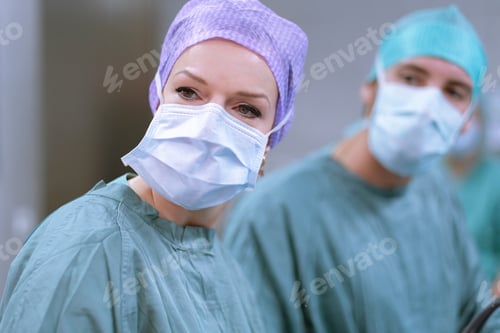 Preview: Neurosurgeons in scrubs during an operation