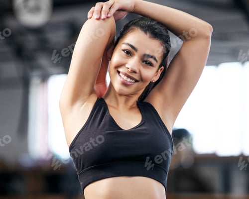 Preview: Stretch it out, work it out. Portrait of a fit young woman stretching in a gym.