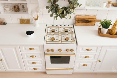 Preview: Modern new light wooden kitchen interior with white furniture and kitchen utensils
