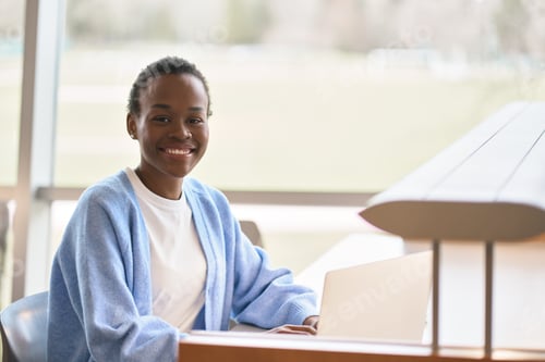 Preview: Happy smiling African Black girl student using laptop computer, portrait.