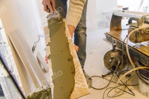Preview: smear the tile repair in the house with a solution. Selective focus.