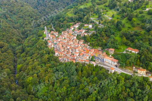Preview: Arial view on mountain Italian village, Garzeno. High angle view of houses with red roofs amoung