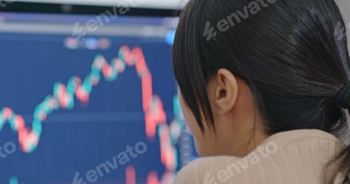 Preview: Woman work on computer with stock market at home
